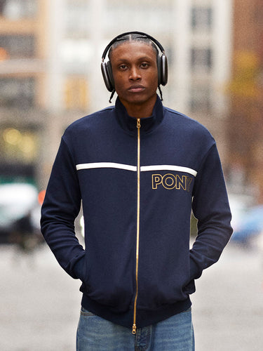 Homepage Banner - Apparel Banner - Jonathan Richetts from PONY Product Of _______ Campaign in PONY Navy Track Jacket