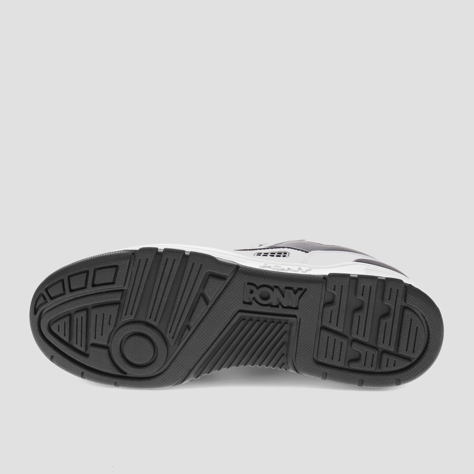 A shot of the black sole of a low-top white and black M-100 sneaker