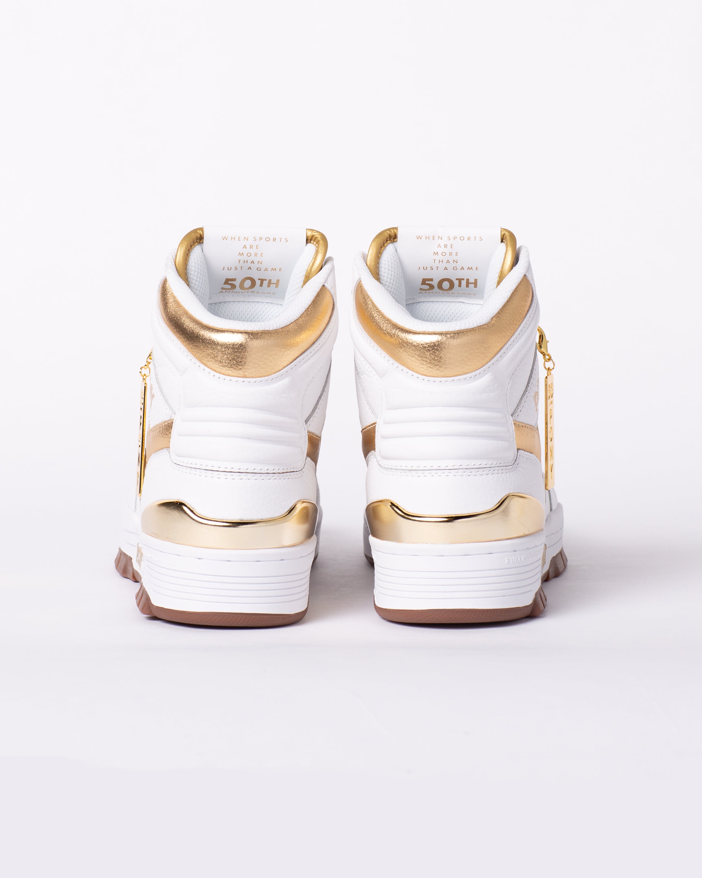 PONY M100 gold and white high top with inside tongue showing "When SPORTS ARE MORE THAN JUST A GAME" 50th anniversary on the inside