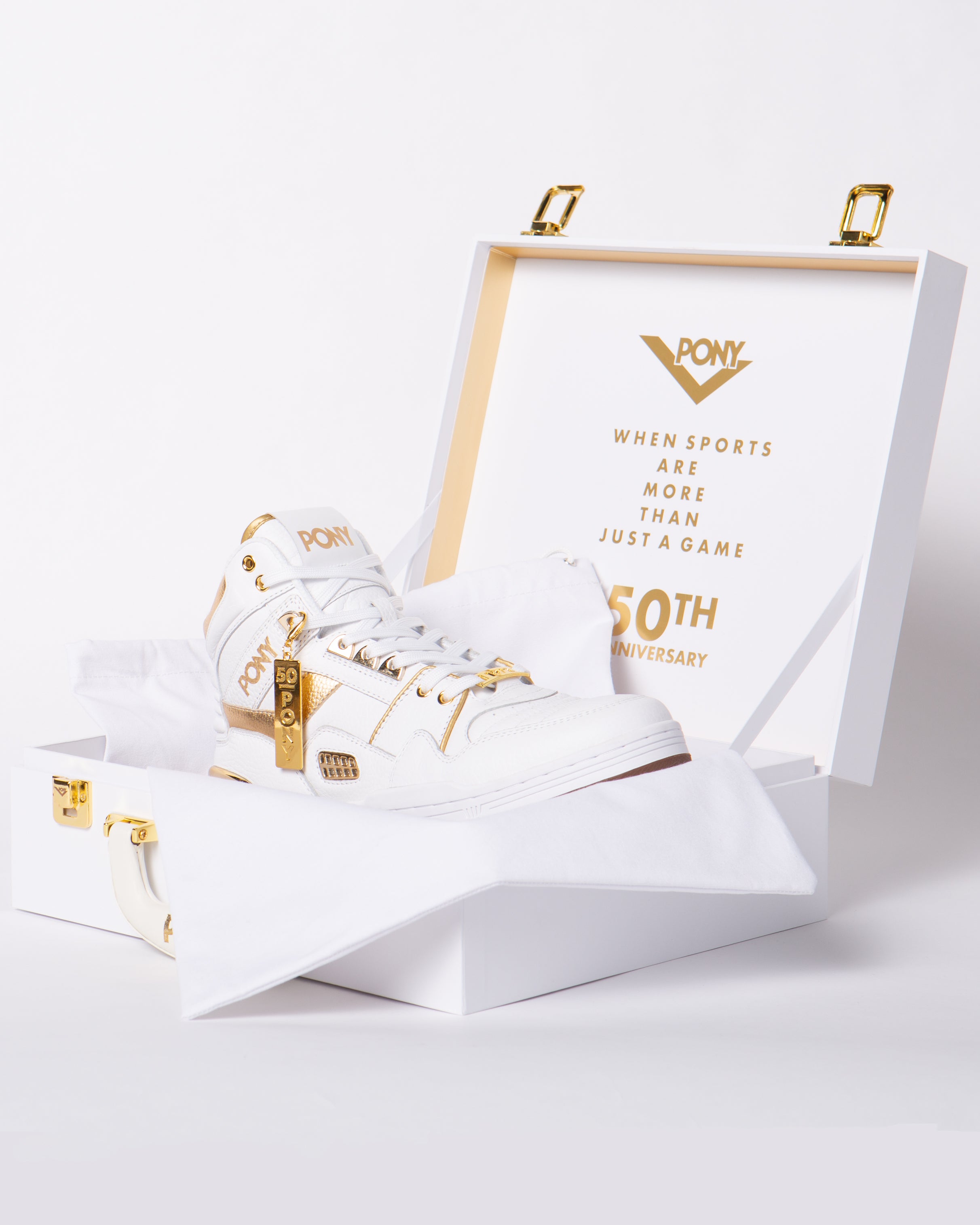 PONY 50th M100 shoe in a its matching limited edition shoebox, white with gold accents and hardware. Inside of box shows PONY lock up with "WHEN SPORTS ARE MORE THAN JUST A GAME" 50th Anniversary on the inside.